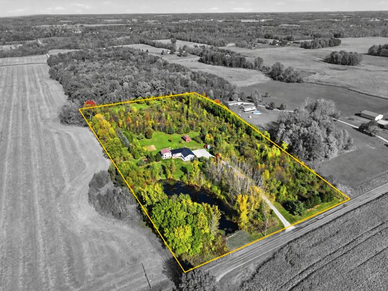 Aerial photo with digital lot lines outlining a wooded acreage property