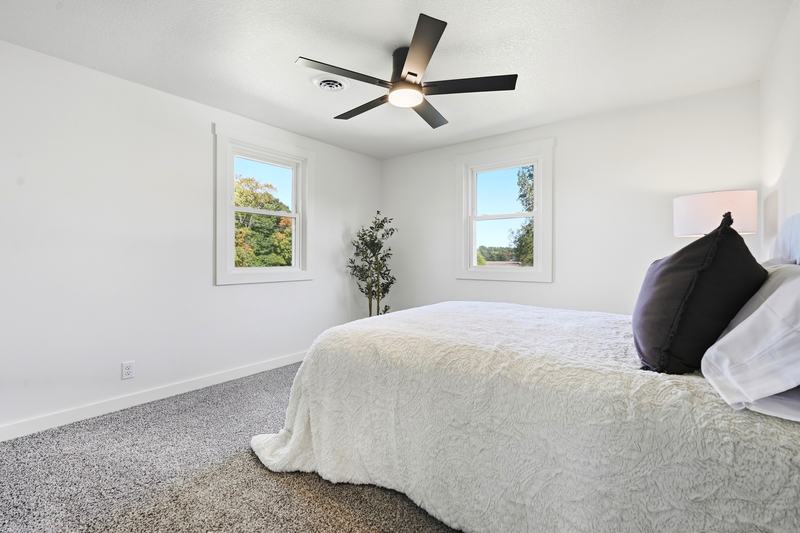 Serene primary bedroom with crisp white bedding and soft natural light