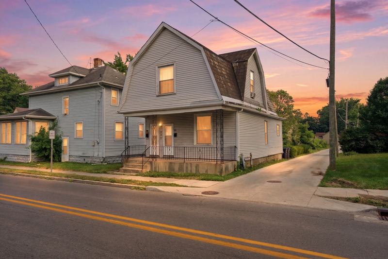 Historic two-story home on a city street at twilight
